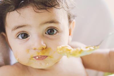 Peanuts are a choking hazard, but early exposure to peanut-based foods may prevent allergies.