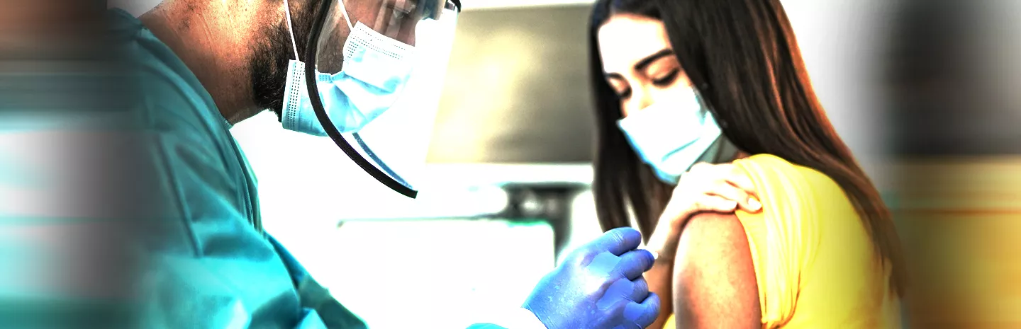 young woman getting a vaccination shot