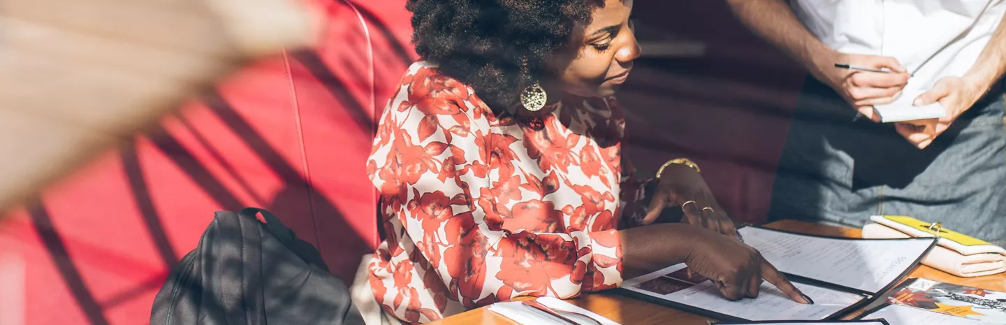 a woman ordering food in a restaurant