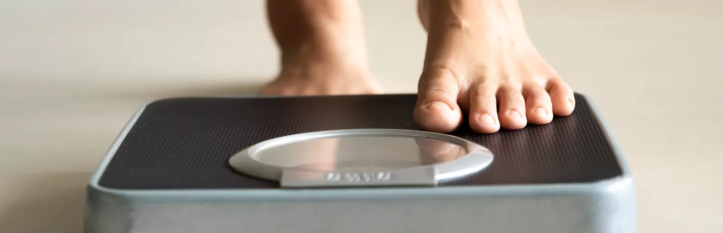 a woman stepping onto a scale