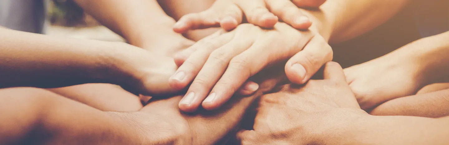 hands meeting in the middle of a group