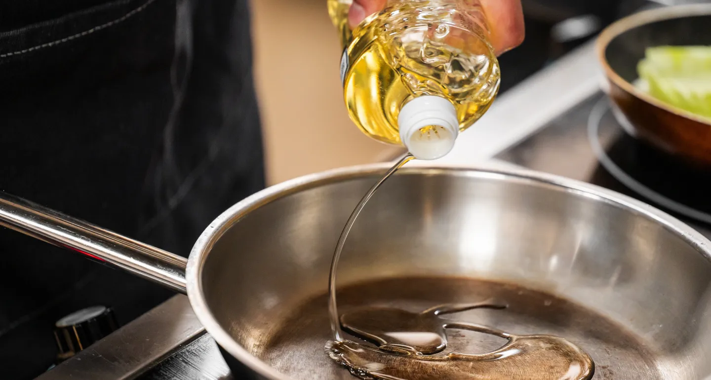 Cooking oil being poured into a pan