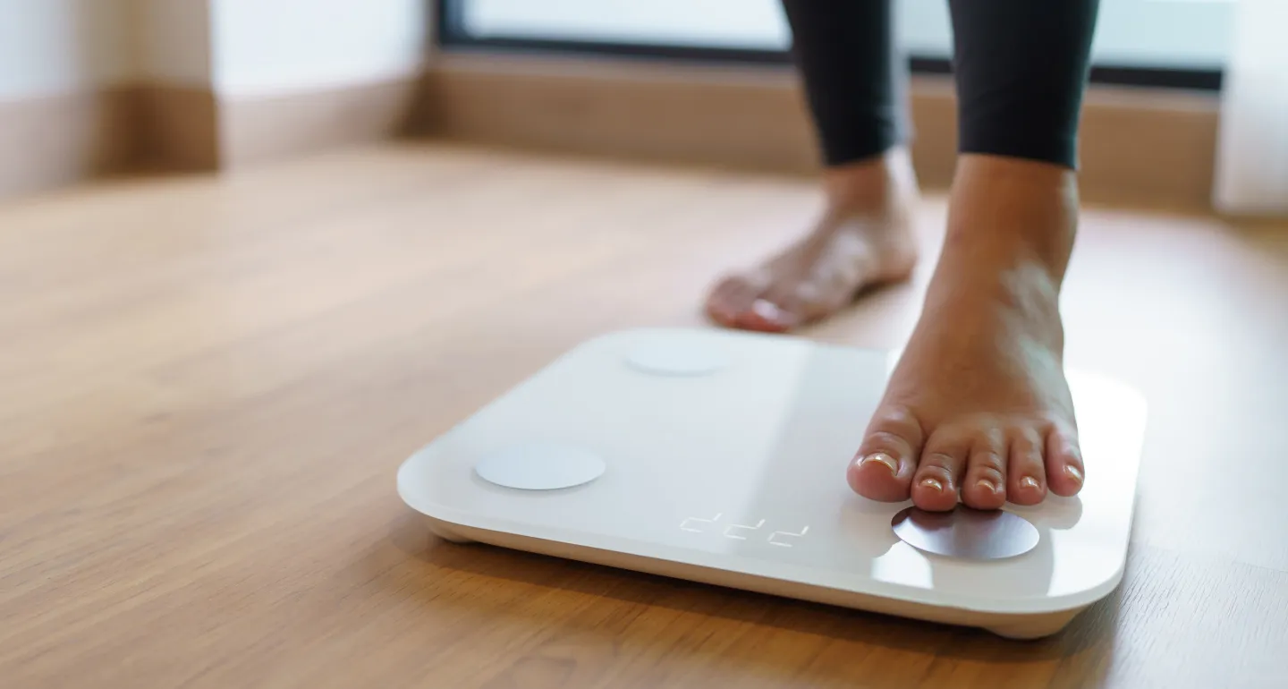 feet stepping onto a scale