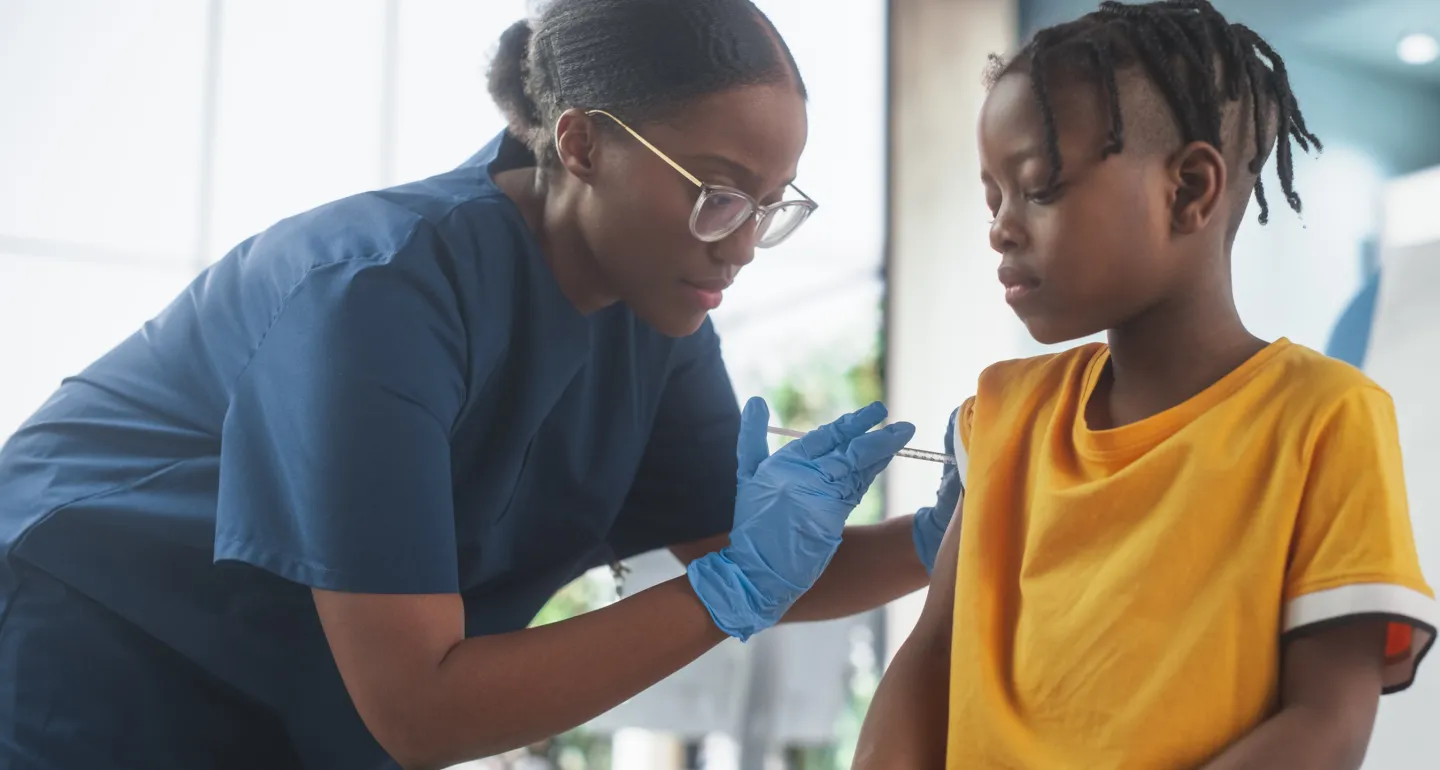 doctor giving child a vaccine in arm