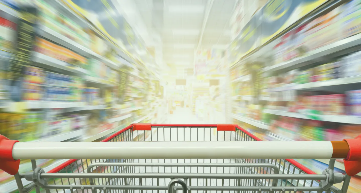 view from behind grocery cart zooming down store isle