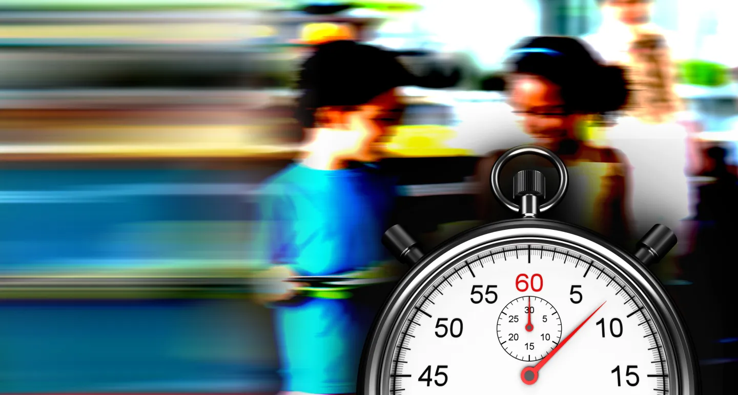 Children holding school lunch trays with a stopwatch in front of them