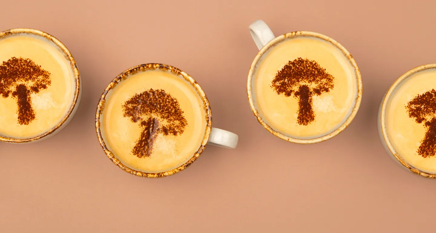 flat lay of mugs with mushroom shaped art