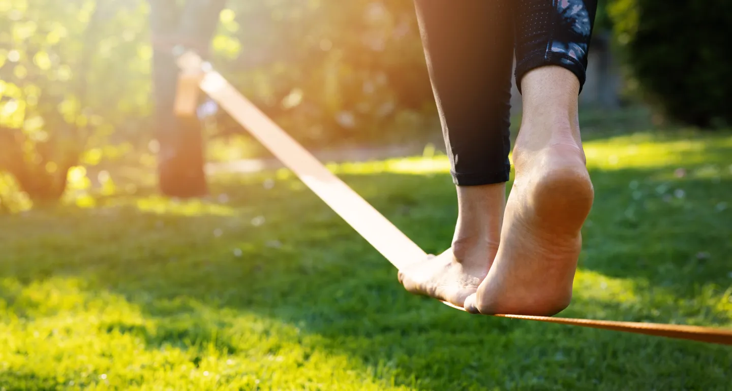 a woman walking on a tightrope
