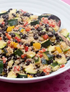 white bowl filled with black bean and quinoa and other vegetables