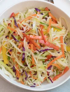 bowl filled with moo shu vegetables and chop sticks