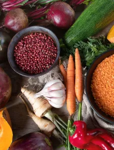 An assortment of fall produce, healthy grains, and dry legumes and lentils
