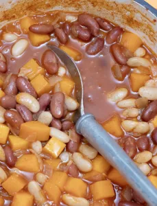 large pot of stew with a grey spoon in the pot