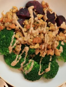 bowl of crispy tempeh, broccoli and purple sweet potato