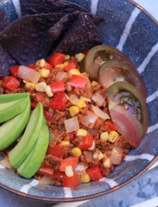 striped blue bowl with chopped vegies and avocado