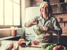 a middle aged woman making a salad