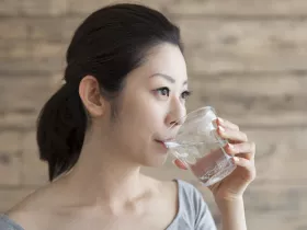 woman drinking a glass of water