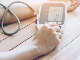 a person using an at home bp monitor