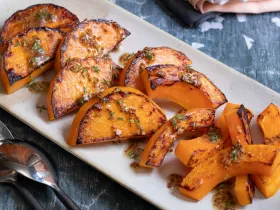 white plate holding slices of cooked butternut squash