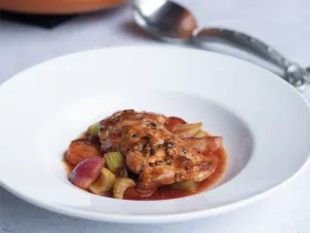 large white bowl with chicken a sauce