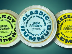 3 tubs of different flavors of Little Sesame hummus with original flavor in the middle.