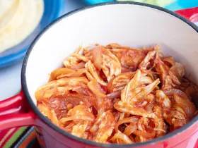 red pot full of pulled chicken 