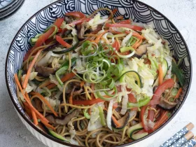 bowl of noodles and cut vegetables