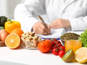Young female nutritionist with healthy food writing diet plan in office, closeup