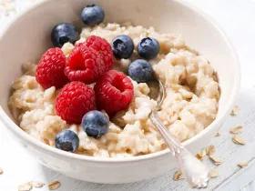 bowl of oatmeal with raspberries and blueberries