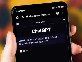 hand holding smart phone that says "ChatGPT" on screen