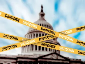 The U.S. Capitol dome behind caution tape with the word SHUTDOWN on it