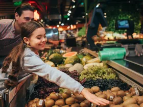 A father and daughter grocery shopping