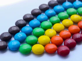 M&Ms candy arranged by color to resemble a rainbow