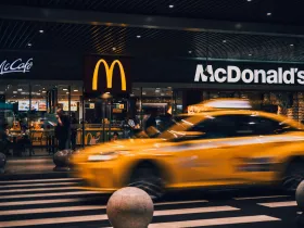 A New York City cab passing a McDonald's at night