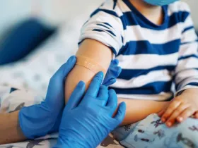 Children's doctor vaccinating little boy against common childhood diseases
