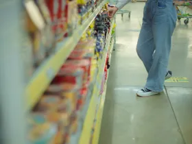 Person browsing packaged foods.