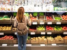 woman in produce section of grocery store