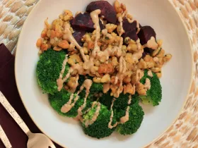 bowl of crispy tempeh, broccoli and purple sweet potato