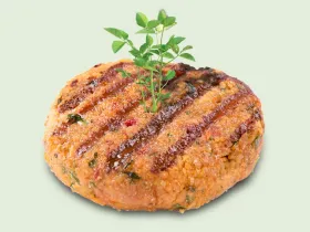 grilled plant based burger patty with green sprout coming out