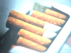 open pack of cigarettes with filter over it