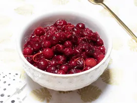 bowl filled with cranberries and sauce