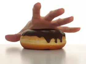 Handing reaching for a donut