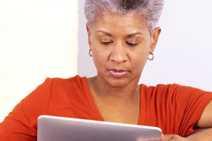a woman reading news on her tablet