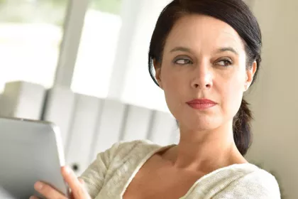 woman holding a tablet screen