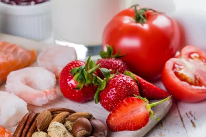 array of foods including tomato, berries, nuts, and shrimp