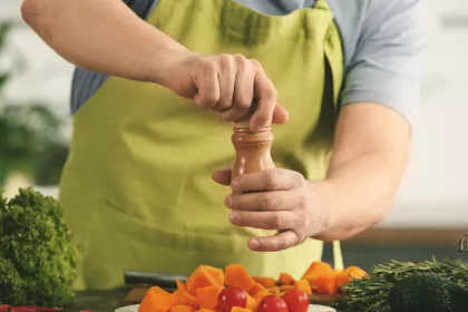 a man seasoning vegetables