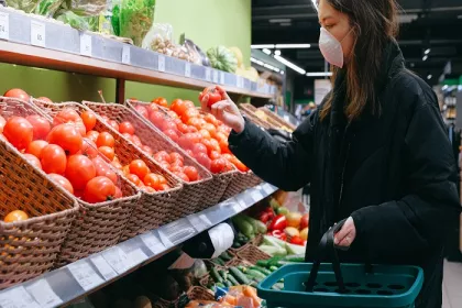 Woman in face mask grocery shopping