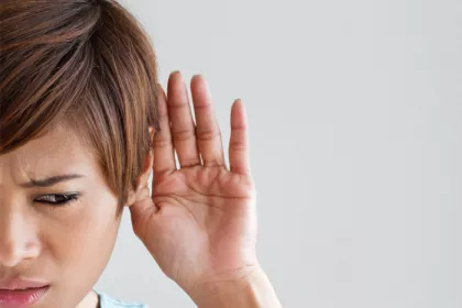 woman with hand to her ear