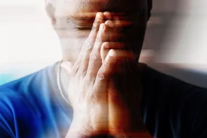 person with head in hands