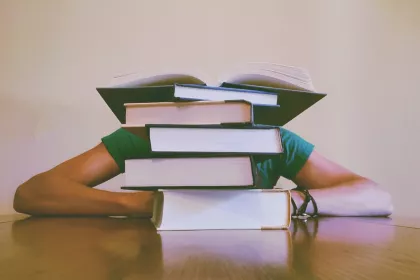 Girl behind books