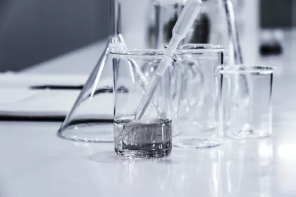 Lab beakers, some containing clear liquid